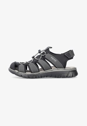 Black sandal featuring a synthetic upper with cutouts, elastic laces, padded heel, and textured rubber sole for grip.