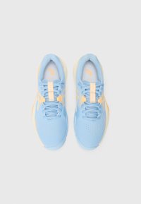 Light blue athletic shoes with yellow accents, breathable mesh upper, perforated design, and textured sole; features flat laces and logo detail.