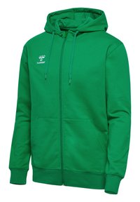 Groene hoodie met rits gemaakt van zacht materiaal. Heeft een voorste rits, twee zakken en een klein wit logo op de borst.