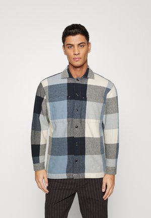 Plaid shirt made of cotton in shades of navy, gray, and light blue, featuring a button-down front and a collar, with long sleeves.