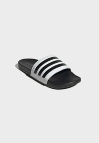 Sorte slidesandaler med en bred hvid rem, der har tre sorte striber, tekstureret overdel og en polstret sort sål.