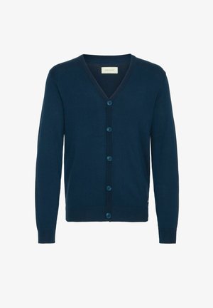 Laivastonsininen neuletakki, V-pääntie, neulottu rakenne, seitsemän napin etuvetoketju, ribbipäät ja helma, sivulla hienovarainen logoelementti.