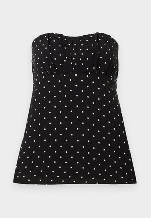 Black strapless top with white polka dots, featuring gathered fabric at the bust, smooth texture, and a relaxed fit.