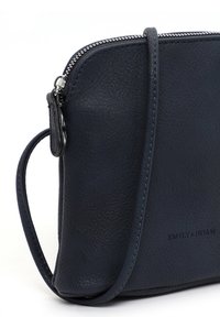Navy blue textured leather crossbody bag with silver zipper and adjustable strap, branded "EMILY & NOAH" on front lower corner.