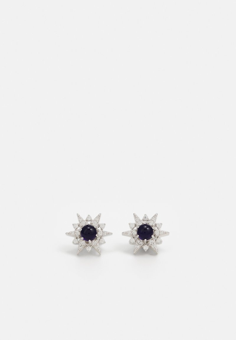 Silver star-shaped earrings with a central black stone, surrounded by sparkling accents. Shiny texture with pointed tips.