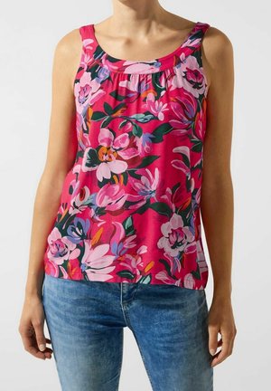 Débardeur fleuri en rose vibrant avec de grands motifs de fleurs colorées. Il possède un col en scoop et un détail froncé au niveau de la poitrine.