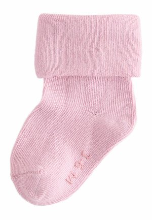 Vaaleanpunainen sukka, joka on valmistettu resorikankaasta ja jossa on käännettävä varsi sekä sileä pinta. Varpaiden läheisyydessä pieni kohokuvioitu kokotieto.