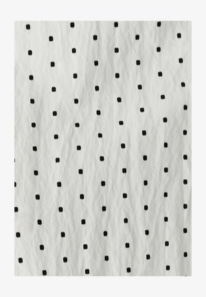 White fabric with black square patterns evenly spaced. The texture appears slightly crinkled, adding depth to the design.