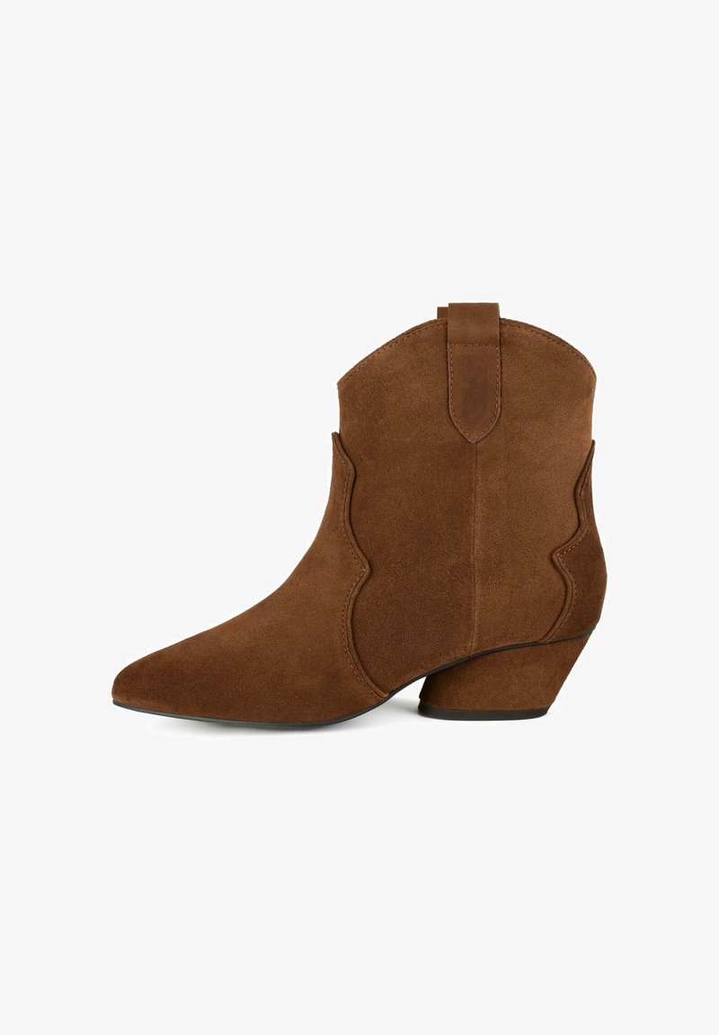 Brown suede ankle boot with pointed toe, tapered heel, and decorative scalloped edges. Textured surface features no visible hardware.