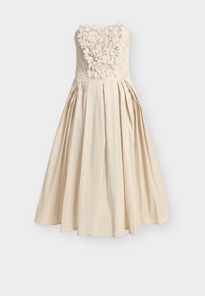 Φόρεμα εκρού χωρίς τιράντες με πλήρη πλισέ φούστα και λεπτομέρειες από τρισδιάστατα λουλούδια στο μπούστο.