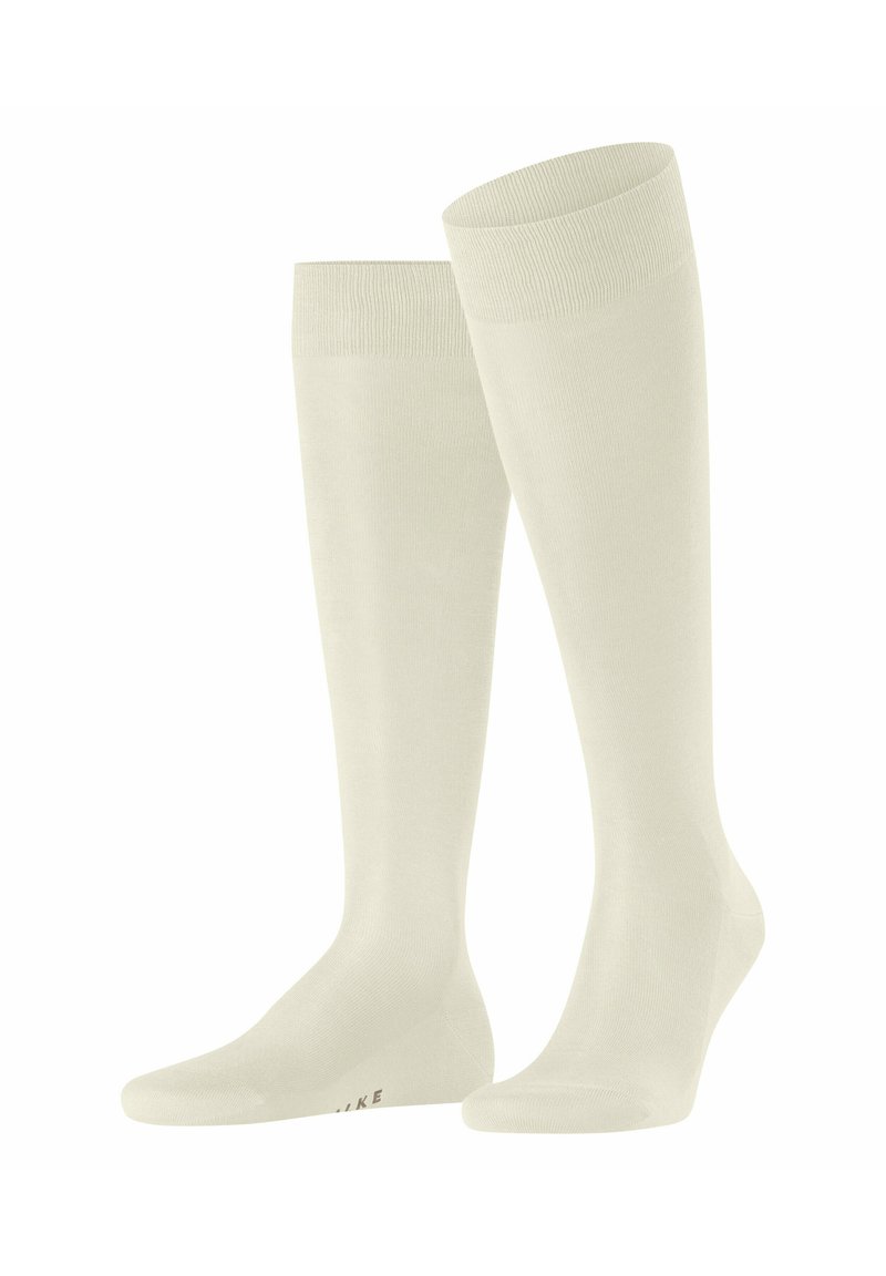 Knielange Socken in cremiger Farbe, aus einem glatten Stoff hergestellt. Mit einem geribten Bündchen und einem Logodetail am Boden.