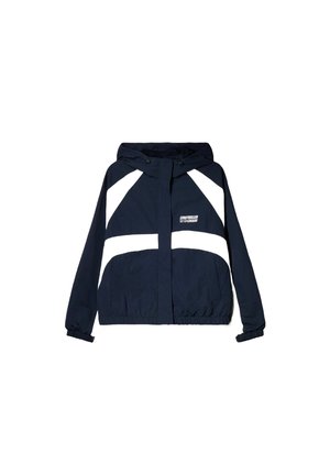 Veste à capuche bleu marine avec des rayures blanches diagonales et horizontales, des poignets élastiques, une fermeture éclair à l'avant et des poches latérales.