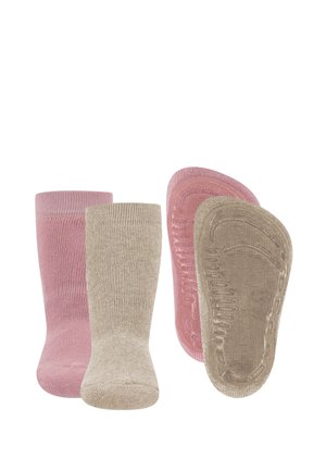 Dwie pary antypoślizgowych skarpetek niemowlęcych, jedna różowa i jedna beżowa, pokazane z przodu i od spodu na białym tle.