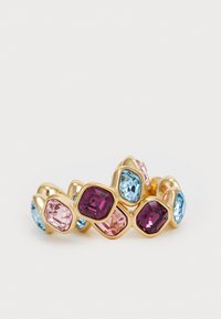 Gold-tone ring featuring a hexagonal design with pink, light blue, and deep purple gemstones arranged asymmetrically. Smooth, shiny texture.