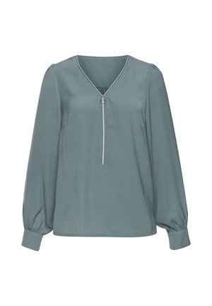 Hellblauer Blusen mit langen Puffärmeln, V-Ausschnitt, silbernem Ringdetail in der Mitte und strukturiertem Stoff. Dezenter Glanz-Finish.