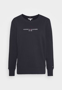 Sudadera de color azul marino con cuello redondo, puños y dobladillo acanalados, que presenta el texto del logo en blanco "TOMMY HILFIGER EST. 1985" en el frente.
