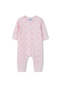 Grenouillère en coton rose avec des manches longues, présentant un motif répétitif de visages de dessins animés, fermeture par boutons-pression à l'avant et poignets côtelés.