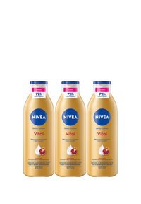 Three gold-colored NIVEA Vital body lotion bottles with blue caps, labeled for 72-hour moisture and pomegranate macadamia serum, arranged side by side.