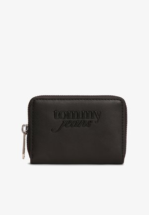 Must nahast rahakott, millel on reljeefne "tommy jeans" logo, lukuga sulgur ja sile pind. Kompaktne ristkülikukujuline disain õmmeldud äärega.