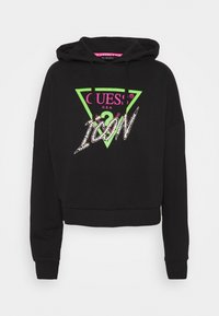 Sudadera corta negra con cordones. Presenta un logo triangular colorido en verde y rosa, con "ICON" decorado con strass.
