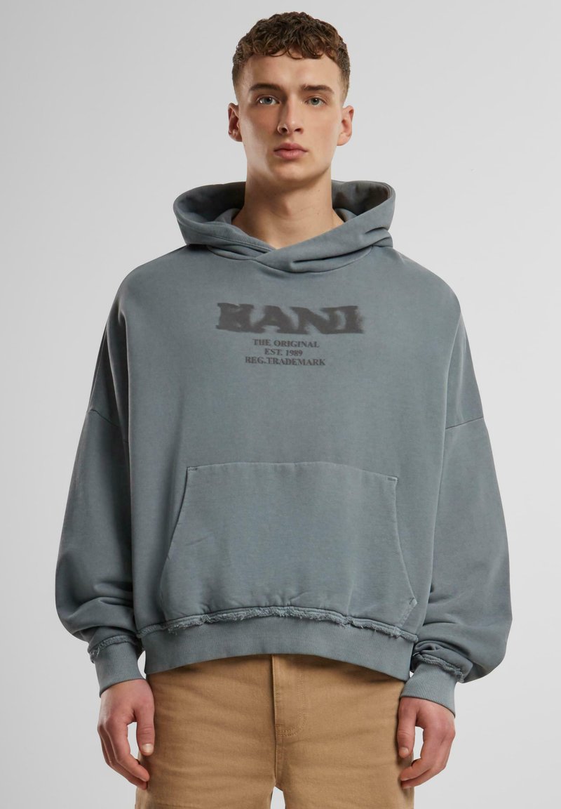 Hooded sweatshirt in faded blue-grey, oversized fit, with a front pocket and distressed hem, featuring printed brand logo on chest.