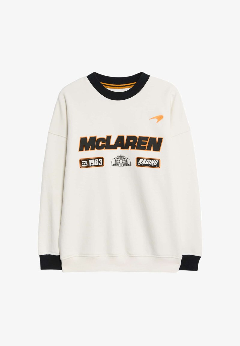 Felpa bianca con accenti neri e arancioni. Presenta una grande scritta "McLAREN", il logo e dettagli grafici. Collo e polsini a coste.