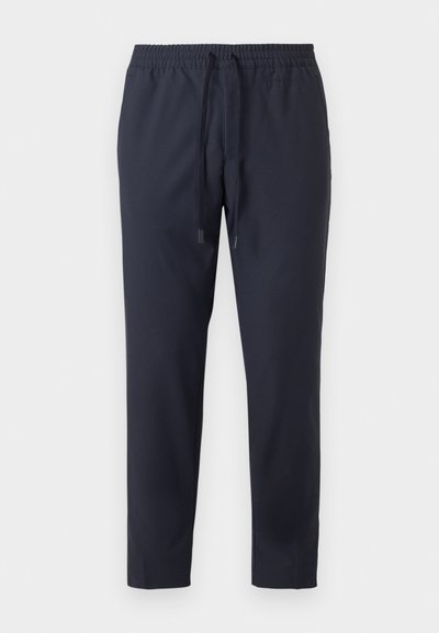 Pantalones de lounge en navy con cintura elástica y cordón ajustable. Fabricados en tejido ligero con una textura suave. Diseño recortado.