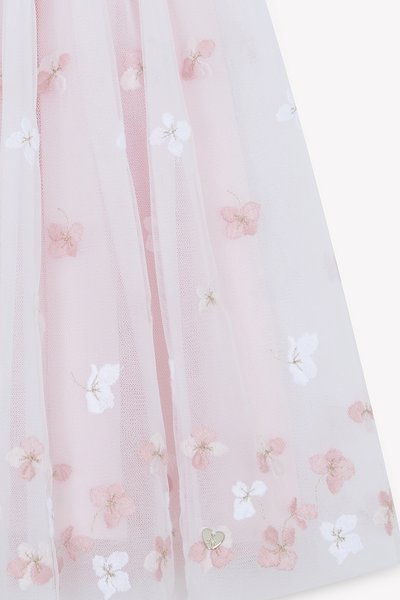 Jupe en tulle rose pâle avec broderie florale blanche et rose, ornée de délicats accents dorés et d'une finition douce et texturée.