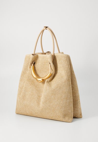 Woven beige handbag with smooth, gold-tone handle, featuring a structured design and two top handles. Simple, elegant style against a white background.
