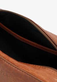 Brown leather bag with a gold-tone zipper, featuring a black fabric interior and a small inner pocket for organization.