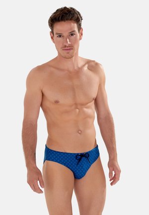 Blaue gemusterte Badeunterhosen mit einem Kordelzug vorne. Der Stoff ist glatt und eng anliegend und weist ein durchgehendes Diamantdesign auf.