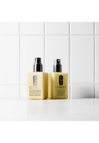 Clinique fuktighetskrem og gel i gule flasker med sølvpumper. Etikettene har svart tekst på hvit bakgrunn. Enkel, rektangulær form.