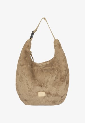 Beige plush handbag with a curved silhouette, soft texture, a single strap, and a gold-tone brand tag on the front.