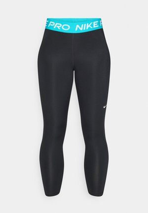 Sorte treningsleggings med en turkis midje som er merket "NIKE PRO." De har en glatt tekstur og en tettsittende silhuett.