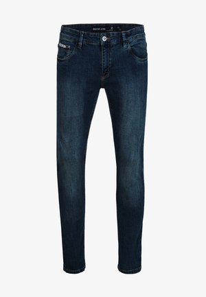 Jean slim bleu foncé avec bouton et fermeture éclair à l'avant, design cinq poches, et détails subtils délavés sur les cuisses et les genoux.