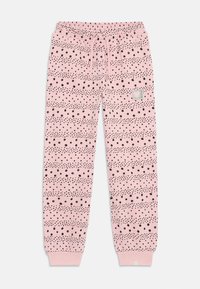 Rosa treningsbukser med svarte prikkede mønstre, elastisk midje, snøring og ribbestrikkede mansjetter. Har en liten merkelapp på venstre side.