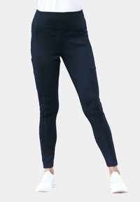 Leggings de sport bleu marine en tissu extensible avec taille haute, poches latérales et coupe ajustée, conçus pour le confort et le mouvement.