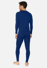 Blå termisk langærmet top og leggings sæt, lavet af struktureret stof, tætsiddende design, med ribbede manchetter og glatte sømme.