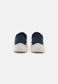 Navy athletic shoes with a textured fabric upper and white rubber sole. Features diamond pattern on the rear and a padded collar for comfort.