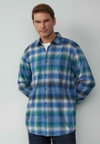 Geruite button-up shirt in blauw, groen en wit. Gemaakt van een geweven stof met een gladde textuur. Standaard kraag en lange mouwen.
