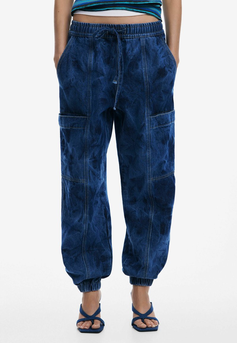Lightweight dark blue denim joggers with an elastic waistband, cinched cuffs, and side pockets; features a faded texture and visible stitching.