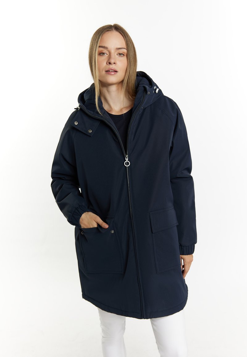 Marineblå parka med hætte, lynlåslukning, elastiske manchetter og to for-lommer. Vandafvisende stof med en glat tekstur.