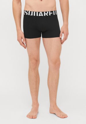 Schwarze Boxer-Briefs aus dehnbarem Material, mit einem breiten weißen Logo-Bund und einem engen Schnitt, der bis zur Mitte des Oberschenkels reicht.
