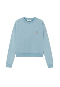 Sweatshirt bleu clair en tissu doux, avec un col rond, des manches longues et une petite broderie en forme de cœur sur la poitrine gauche.