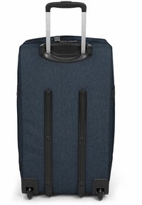 Valigia in tessuto blu navy con manico estraibile, accessori in metallo neri, quattro ruote e fondo rinforzato per una maggiore durata.