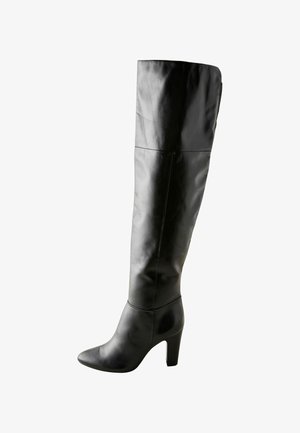 Juodas odinis ilgas iki kelių bootas, su prigludusia forma, smailiu nosiniu ir aukštu kulnu. Lygi tekstūra, minimalistiškas dizainas, be matomų raštų.