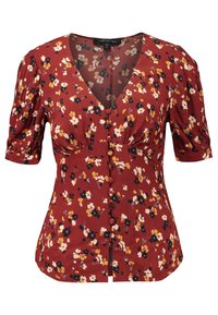Blusa roja con flores, con mangas abullonadas, escote en V y cierre de botones en la parte delantera. El estampado incluye flores amarillas, negras y blancas sobre una tela texturizada.