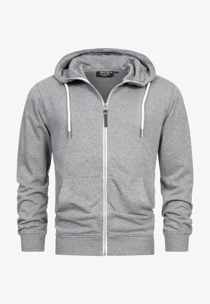 Felpa con cappuccio grigia con zip, realizzata in tessuto morbido, dotata di cerniera frontale, due tasche laterali e cappuccio con coulisse. Design semplice con polsini a costine.