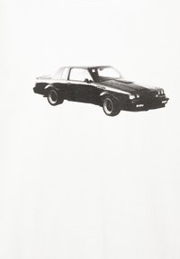 Grafisk print af en sort bil på en hvid stofbaggrund. Bilen har et klassisk design med runde kanter og fremtrædende hjul.
