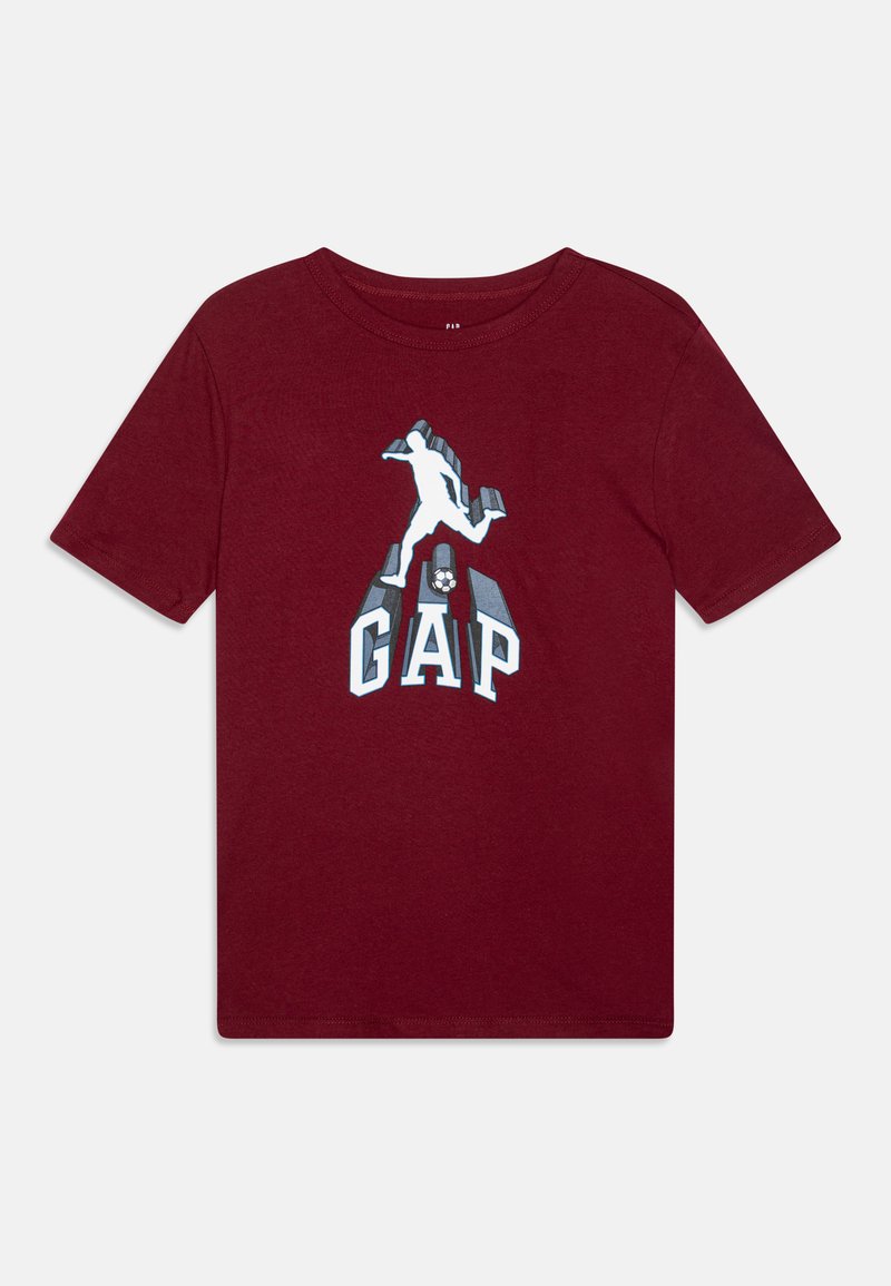 Bordová bavlněná tričko s grafickým designem skákající postavy s textem "GAP" pod ní. Krátké rukávy a standardní kulatý výstřih.